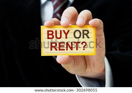 Buy or Rent? card in hand of Real Estate agent