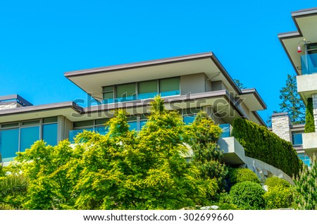 Big custom made luxury modern house with nicely landscaped front yard in the suburbs of Vancouver, Canada.
