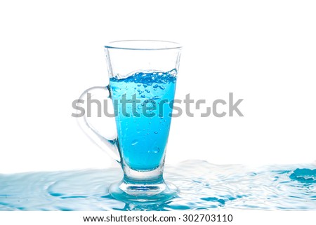 Water splashing into glass of water on white background