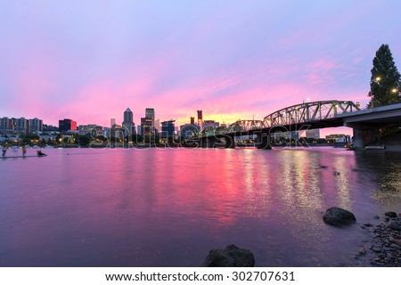 Pink Sunset over Portland Oregon downtown waterfront city skyline along Willamette River by Hawthorne Bridge