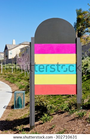 Sign with blank color panels off a residential street. 