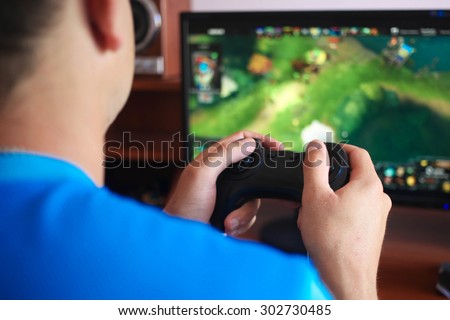 Man hand playing a computer games Royalty-Free Stock Photo #302730485