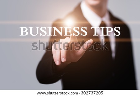 business, technology, internet and networking concept - businessman pressing business tips button on virtual screens