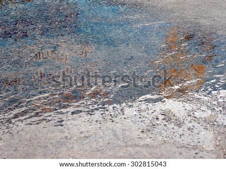 Oil spill on asphalt road background or texture 