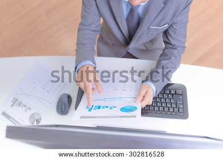Businessman analyzing investment charts with computer. Accounting