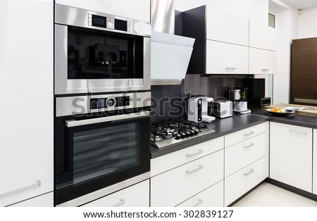 Modern luxury hi-tek black and white kitchen interior, clean design Royalty-Free Stock Photo #302839127
