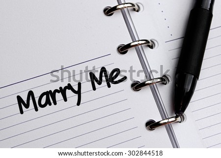 Marry Me word written on notebook