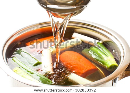 pour broth transparent to the broth pot on white background
