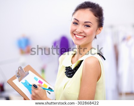 Modern young fashion designer working at studio