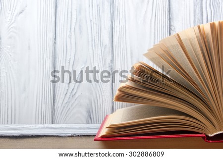 Open book on wooden table. Back to school. Copy space