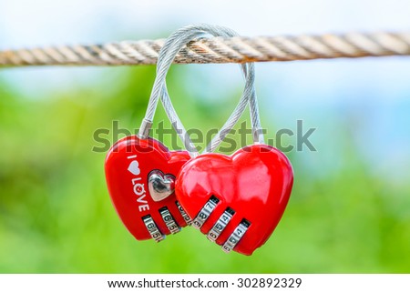 Two heart shaped love padlocks on the bridge as a symbol of eternal love and endless love.