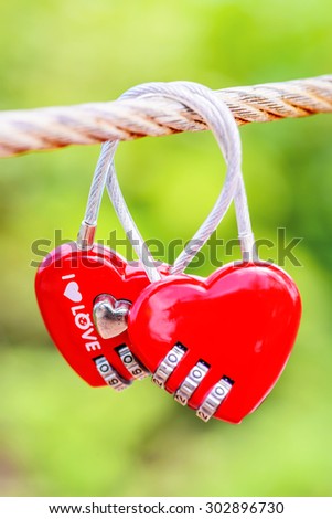 Two heart shaped love padlocks on the bridge as a symbol of eternal love and endless love.