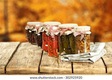 few glasses jar on wooden retro table and golden blurred backgroun 