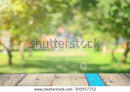 Blur park with nature green bokeh on wood abstract background.