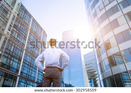career concept, business background, man looking at office buildings Royalty-Free Stock Photo #302958509