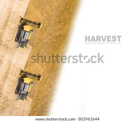 Aerial view of combine harvester on wheat field. Industrial background on agricultural theme. Picture with space for your text.