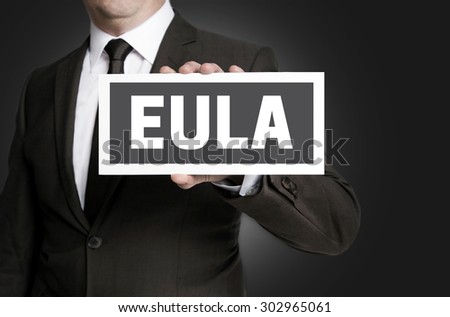 Eula sign is held by businessman.