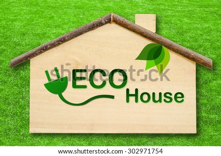 Eco home on Little home wooden model on green grass background. Save clipping path