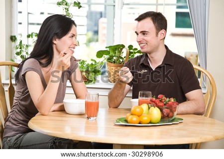 A shot of a couple eating their breakfast at home