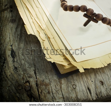 Bible and rosary on the wooden background