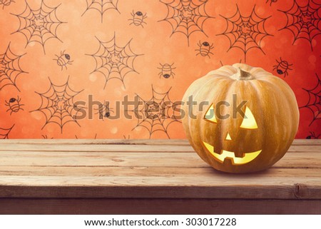 Halloween holiday background with pumpkin on wooden table