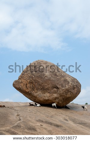 Krishna's butterball, the giant natural balancing rock in Mahabalipuram, Tamil Nadu, India Royalty-Free Stock Photo #303018077