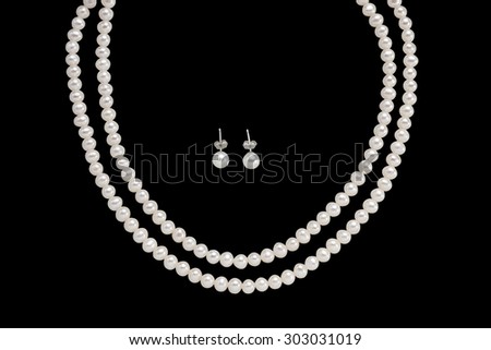 Pearl Earring and necklace isolated on black background
