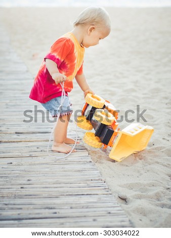 Baby playing with toy car