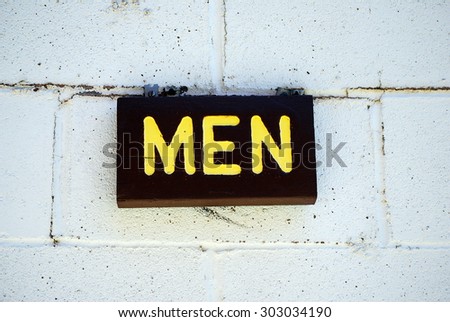 Men's restroom sign displayed outdoors.