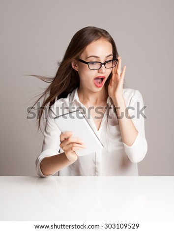 Portrait of young brunette woman with her tablet computer.