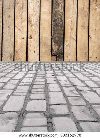 brick floor with a wooden wall