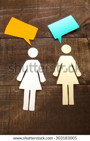 Two paper woman talking illustration on wood background