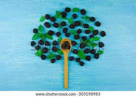 Tree of blackberries on a blue wooden background