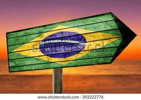 Brazil flag wooden sign with a beach background