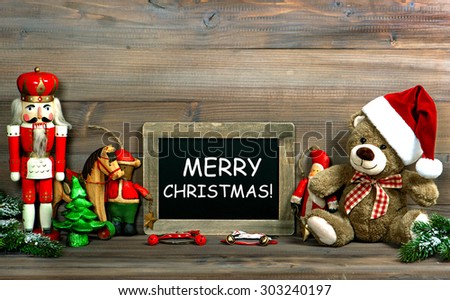 Christmas decoration with antique toys and blackboard. Vintage style toned picture with sample text Merry Christmas