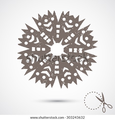 Paper snowflake with scratches on grey background. Silhouette. Handmade, paper cut with scissors. Old style hobby preparation for New year and Christmas Holidays.