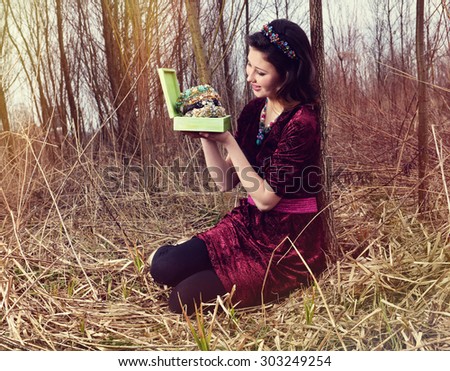 Picture, the woman with treasures for hair in nature
