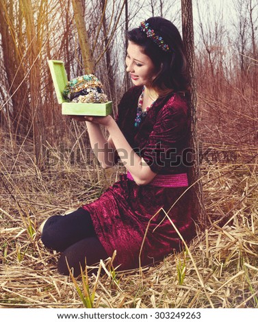 Picture, the woman with treasures for hair in nature,beauty portrait,autumn woman