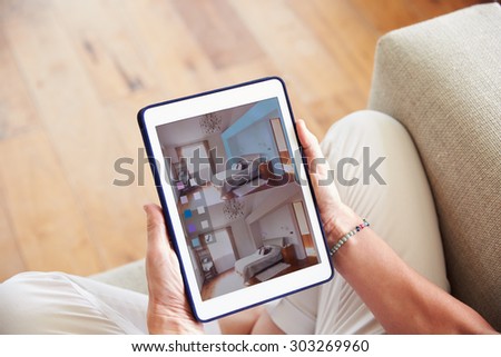 Woman Looking At Decorating App On Digital Tablet