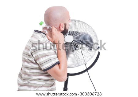Man cooling down with blowing fan and cold water isolated on white