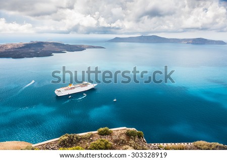 Beautiful landscape with sea view. Cruise liner at the sea near the islands. Santorini island, Greece.  Royalty-Free Stock Photo #303328919