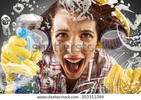 Desperate housewife screams while cleaning the glass Royalty-Free Stock Photo #303353384