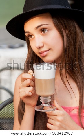 Gorgeous young woman having summer refreshments.