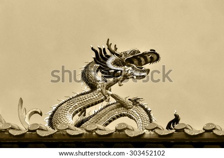 Dragon on the roof of a Chinese temple in Yangon, Myanmar.  
Dragon is on the rooftop of the Kheng Hock Keong Buddhist  Temple in China Town Yangon. Monochrome picture.