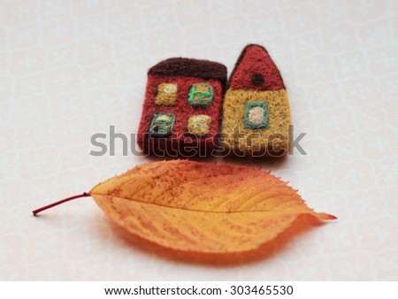 toy houses and autumn leaf