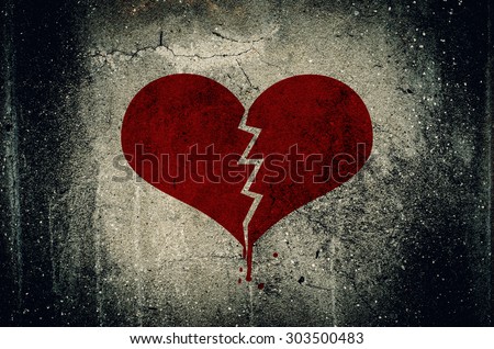 Heart broken painted on grunge cement wall background - love concept Royalty-Free Stock Photo #303500483