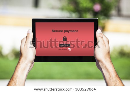 Secure payment web page in a tablet screen with red background.