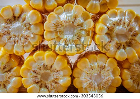 Freshly harvested corn on wooden background, corn oil