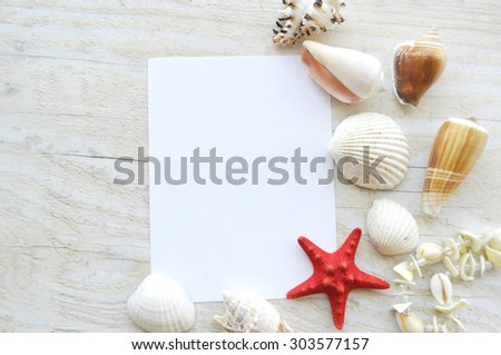 Beautiful sea composition with shells on wooden background.Summer frame with seashells, close-up.Decor of seashells, starfish and old paper