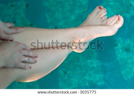 beautiful woman feet relaxing in the clear water